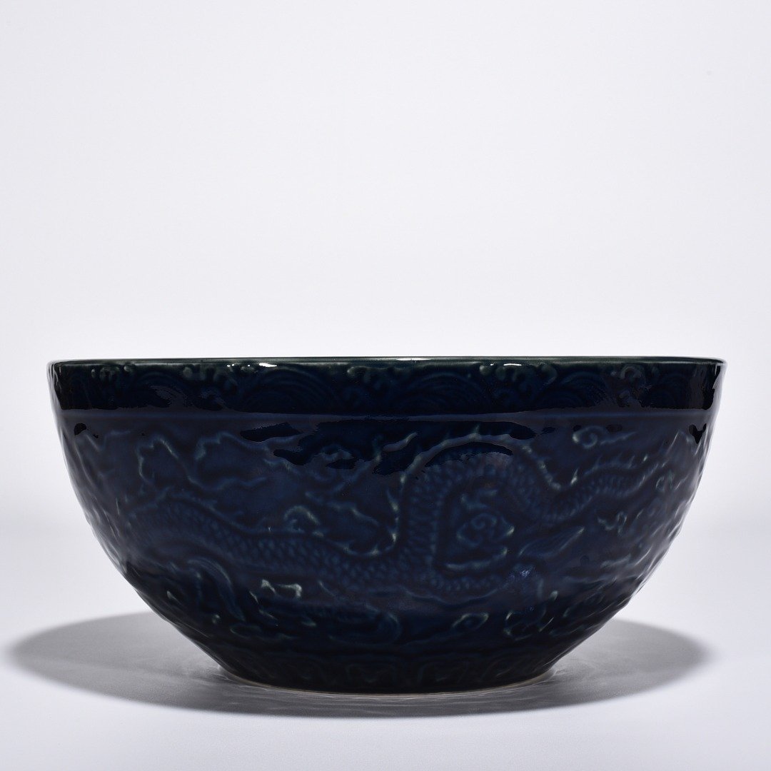 Ming Dynasty Xuande blue glaze bowl with carved cloud and dragon pattern