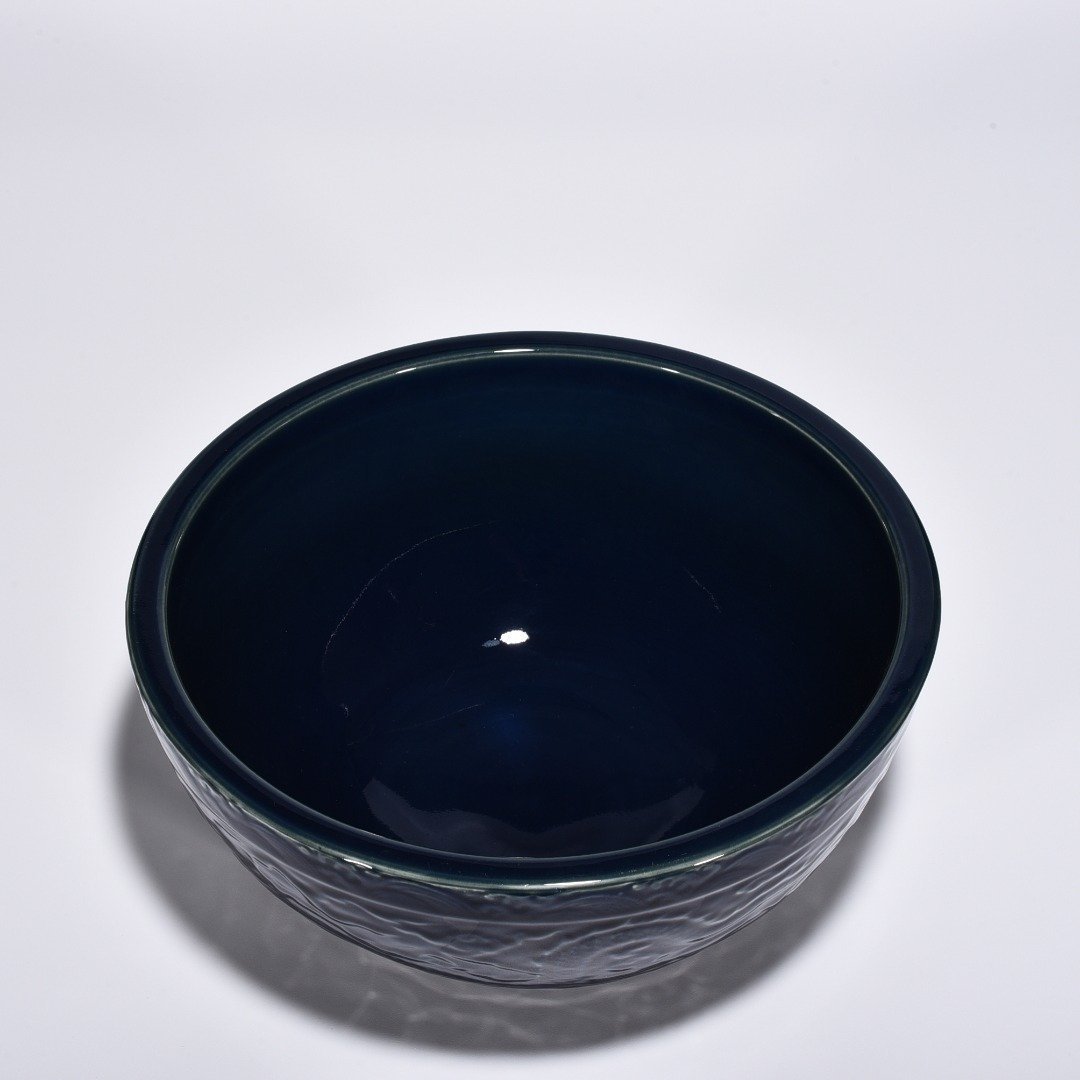 Ming Dynasty Xuande blue glaze bowl with carved cloud and dragon pattern