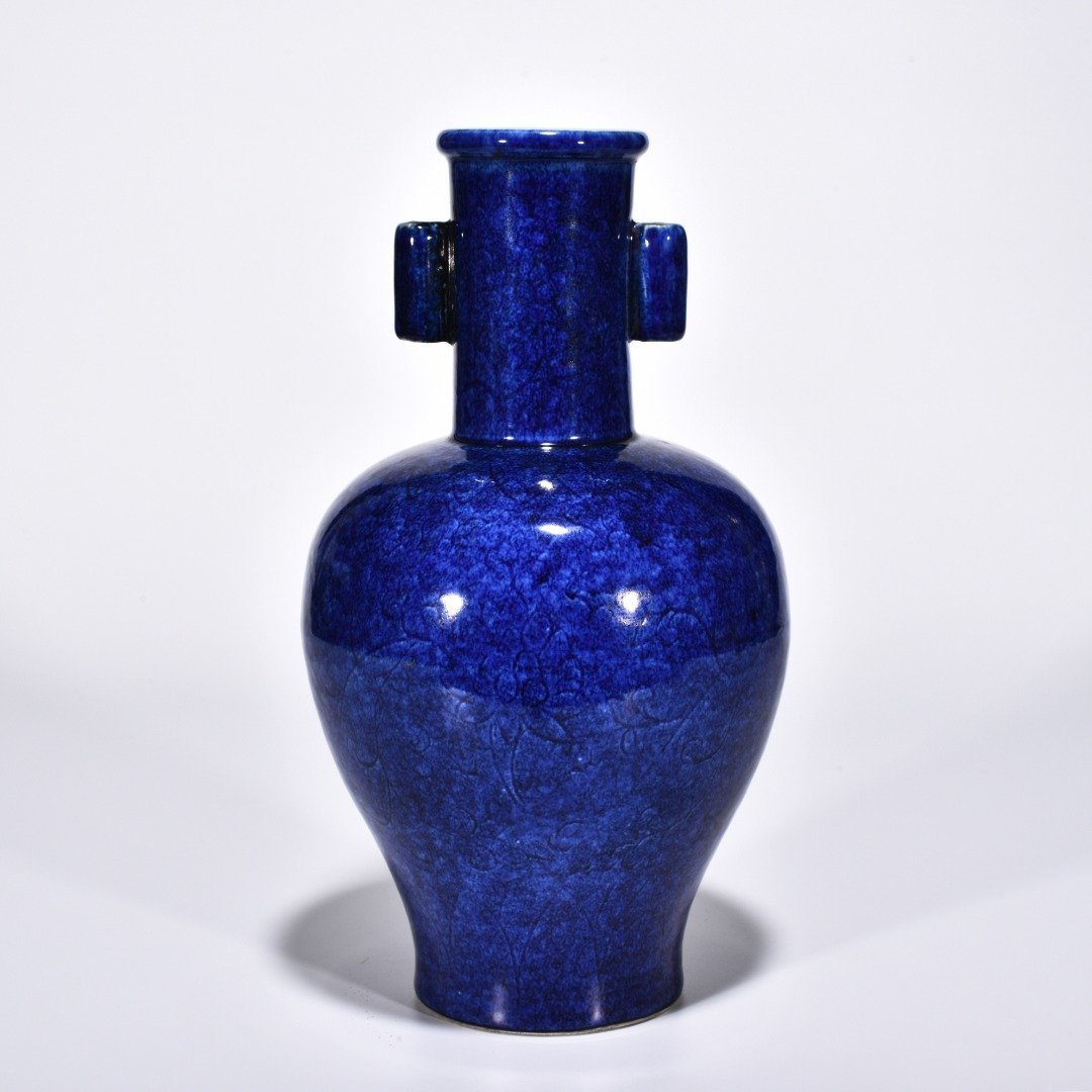 Ming Dynasty Xuande blue and white glaze engraved flower pattern through-ear vase