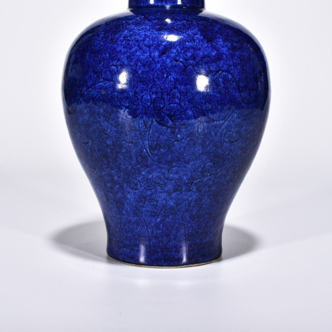 Ming Dynasty Xuande blue and white glaze engraved flower pattern through-ear vase