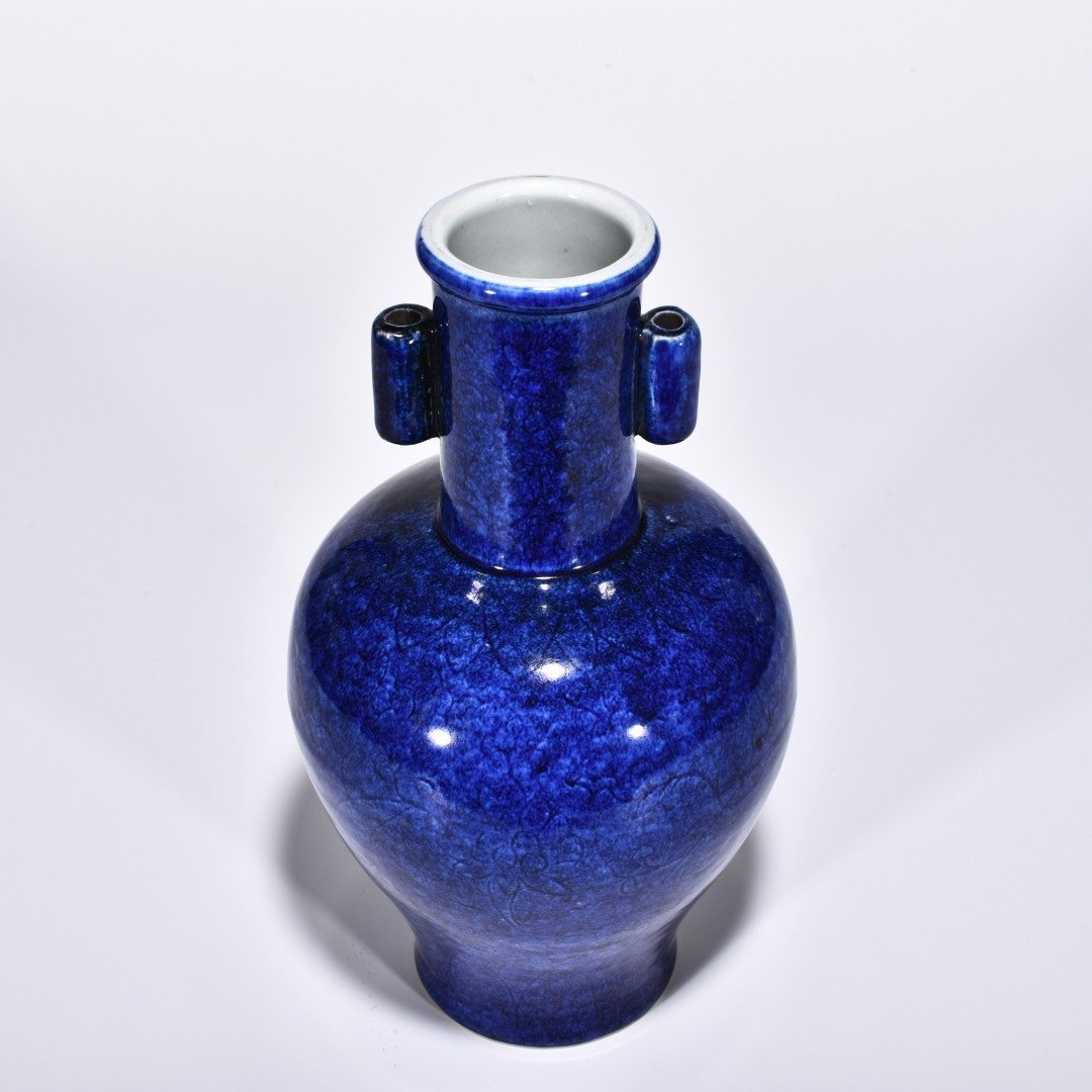Ming Dynasty Xuande blue and white glaze engraved flower pattern through-ear vase