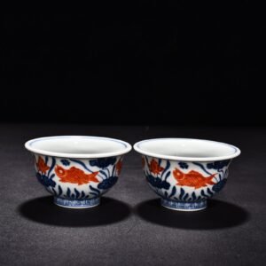 Ming Dynasty Xuande blue and white alum red fish and algae pattern pressed hand cup