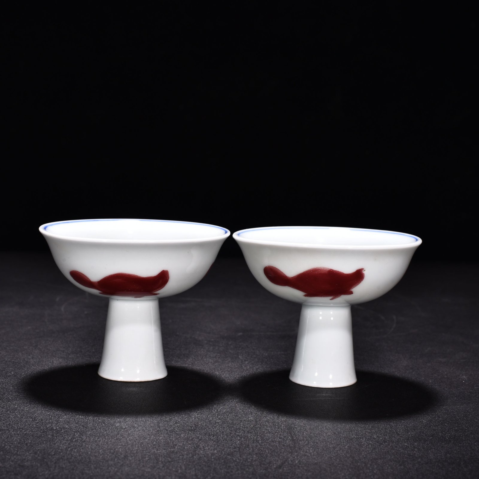 Ming Dynasty Xuande blue and white underglaze red wheel pattern three-fish goblet