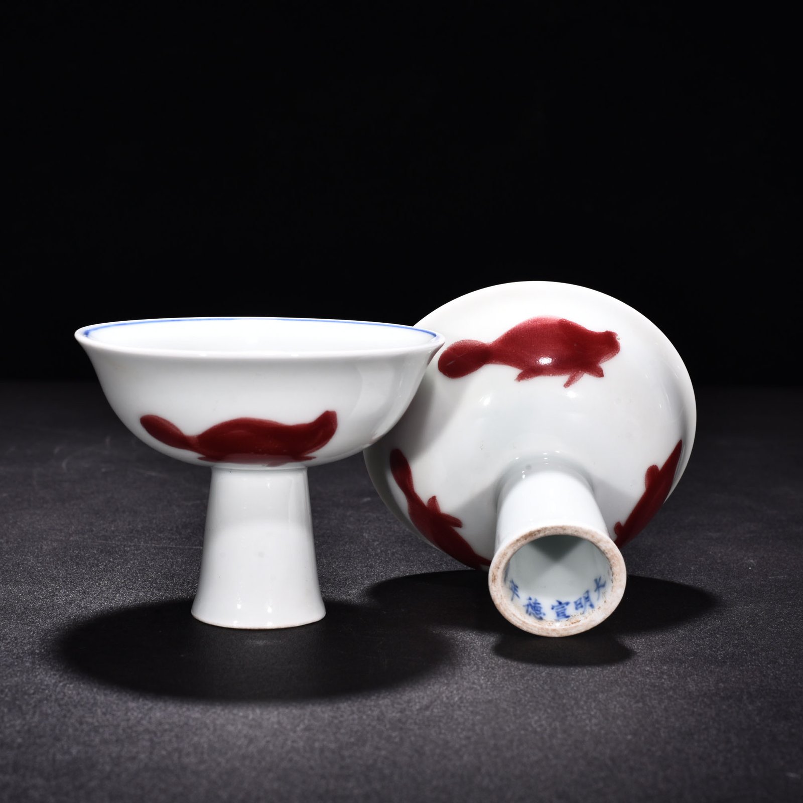 Ming Dynasty Xuande blue and white underglaze red wheel pattern three-fish goblet