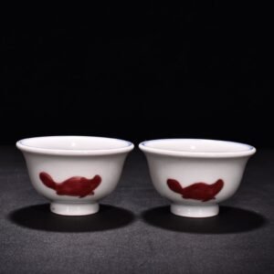 Ming Dynasty Xuande blue and white underglaze red fish and algae pattern three-fish pressing cup