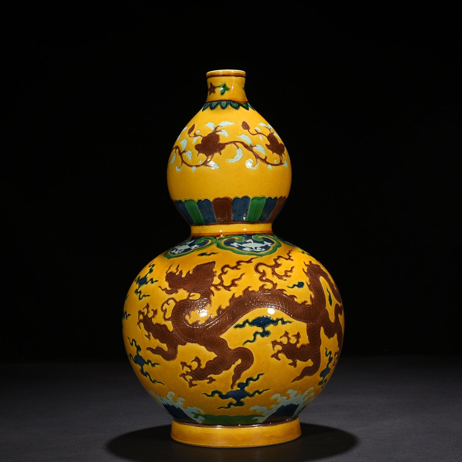 Ming Dynasty Xuande yellow ground three-color carved gourd bottle with dragon