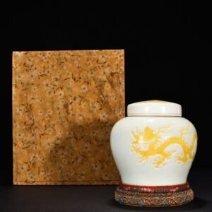 Ming Dynasty Hongzhi yellow glaze engraved cloud and dragon pattern lid jar