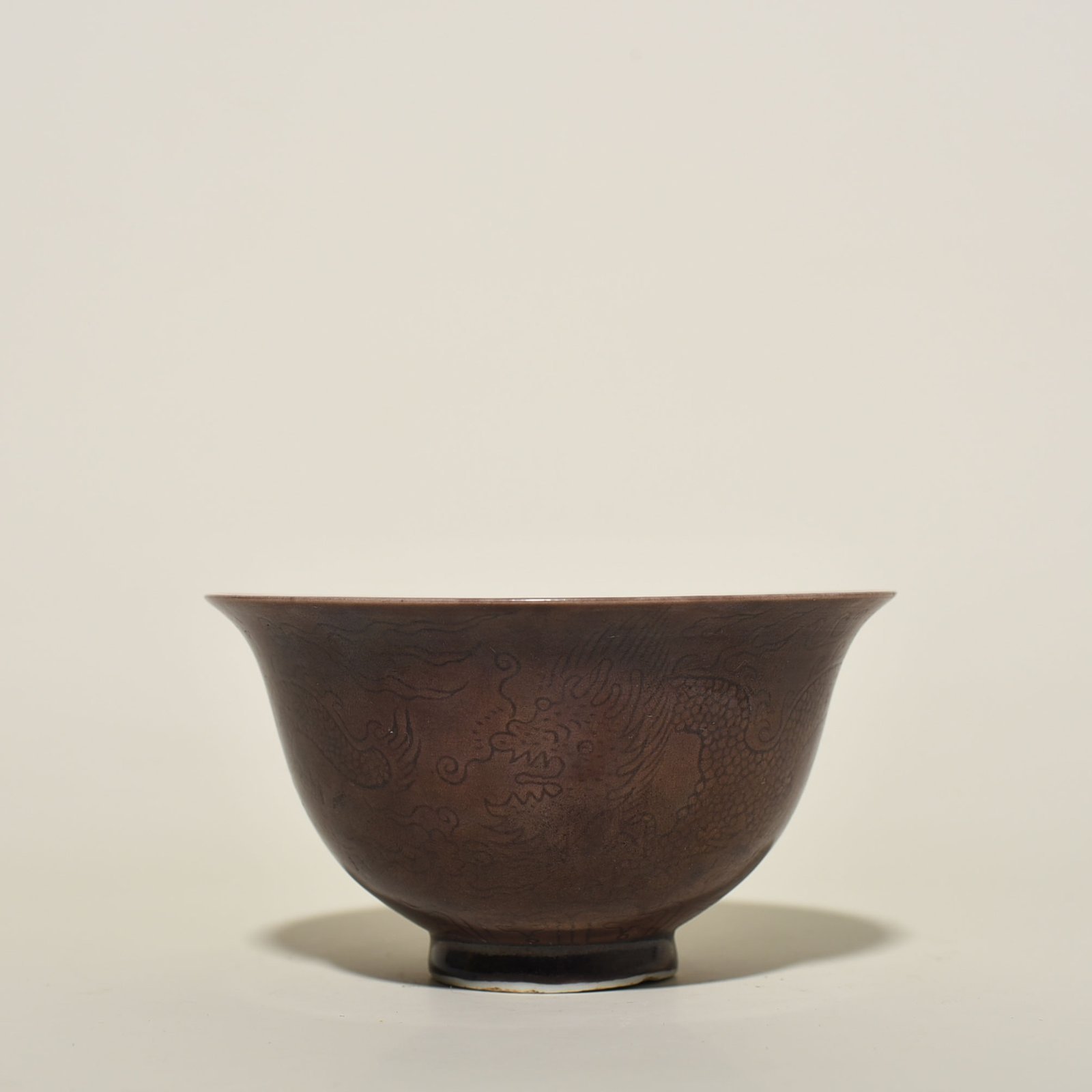 Ming Dynasty Chenghua eggplant skin purple glaze engraved dragon bowl