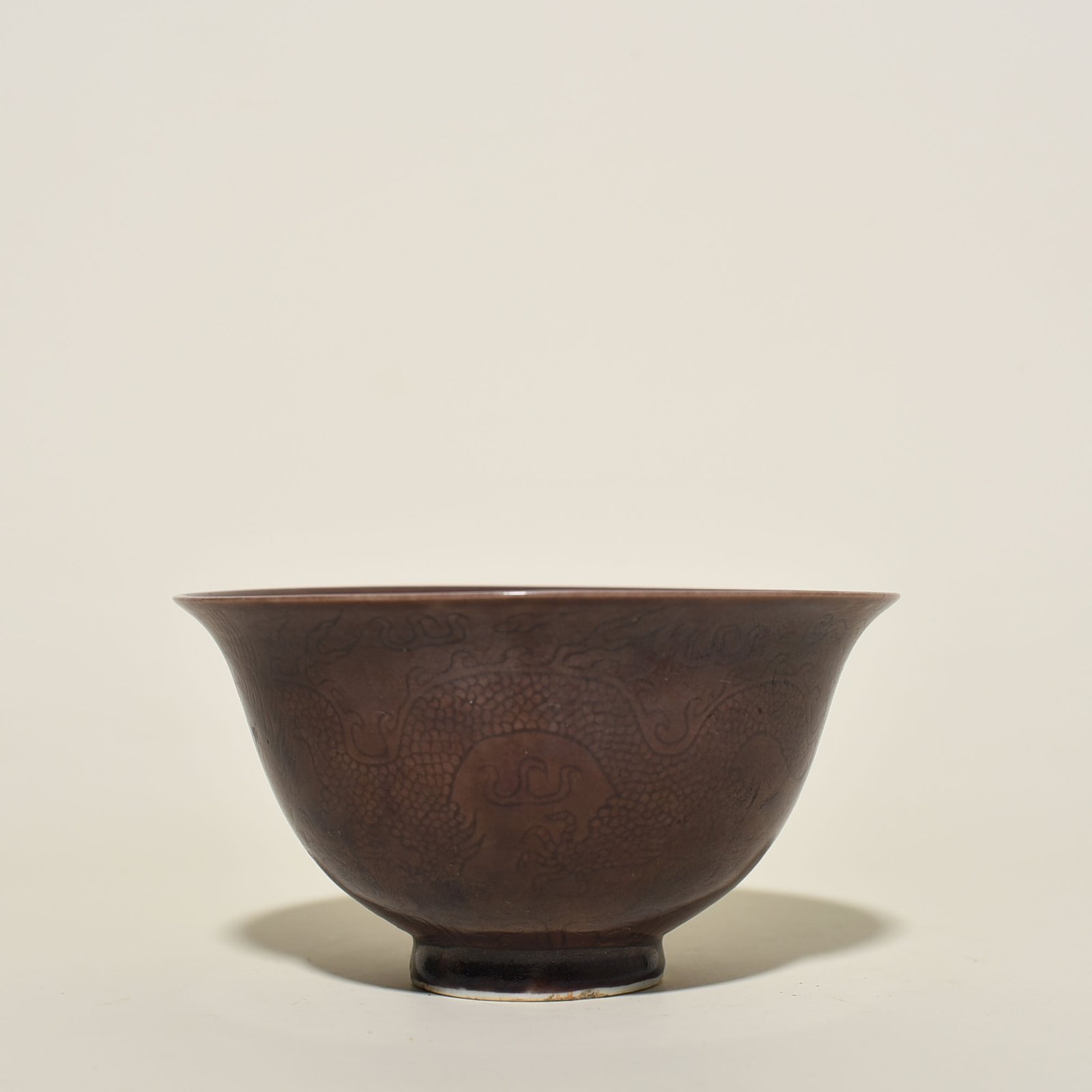 Ming Dynasty Chenghua eggplant skin purple glaze engraved dragon bowl