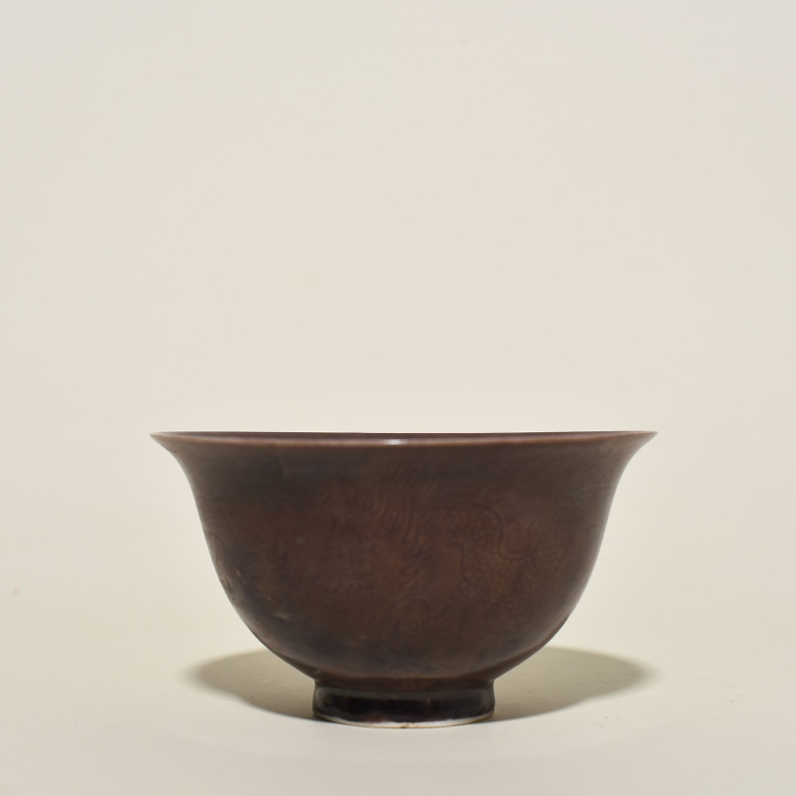 Ming Dynasty Chenghua eggplant skin purple glaze engraved dragon bowl