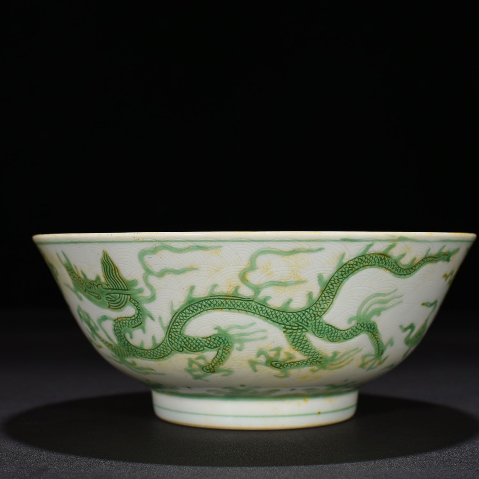Ming Dynasty Chenghua carved seawater green dragon bowl
