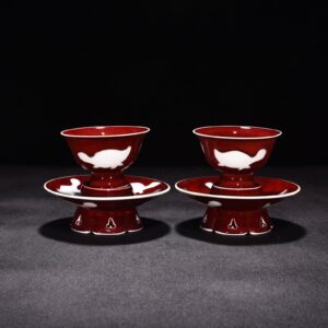 Ming Dynasty Yongle ruby ​​red glazed white engraved three-fish lamp holder