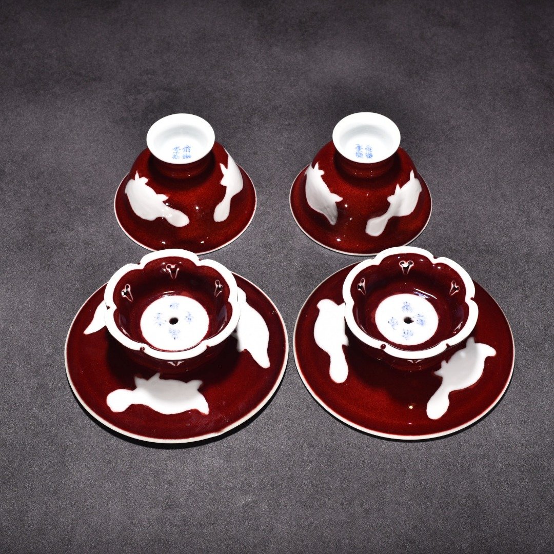 Ming Dynasty Yongle ruby ​​red glazed white engraved three-fish lamp holder