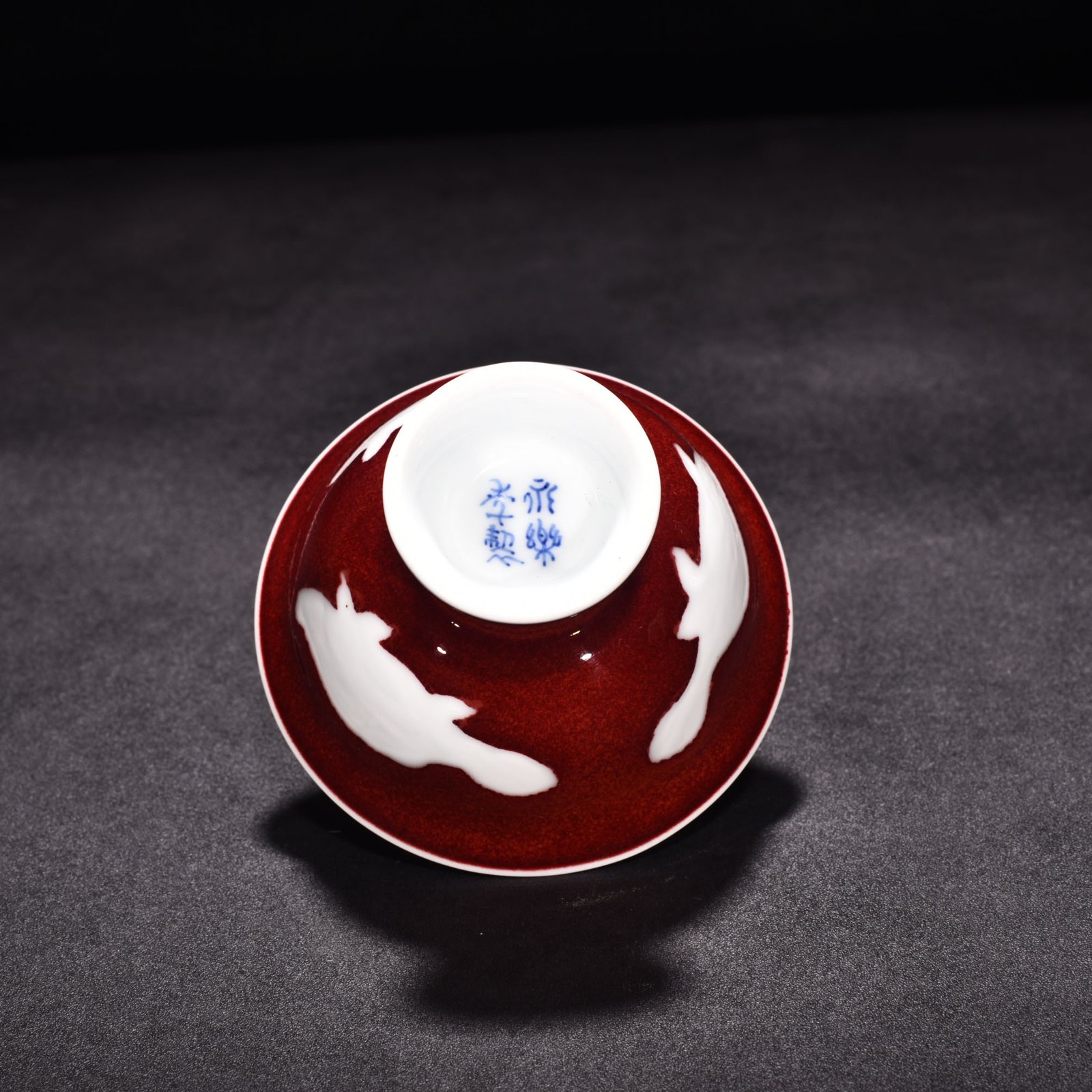 Ming Dynasty Yongle ruby ​​red glazed white engraved three-fish lamp holder