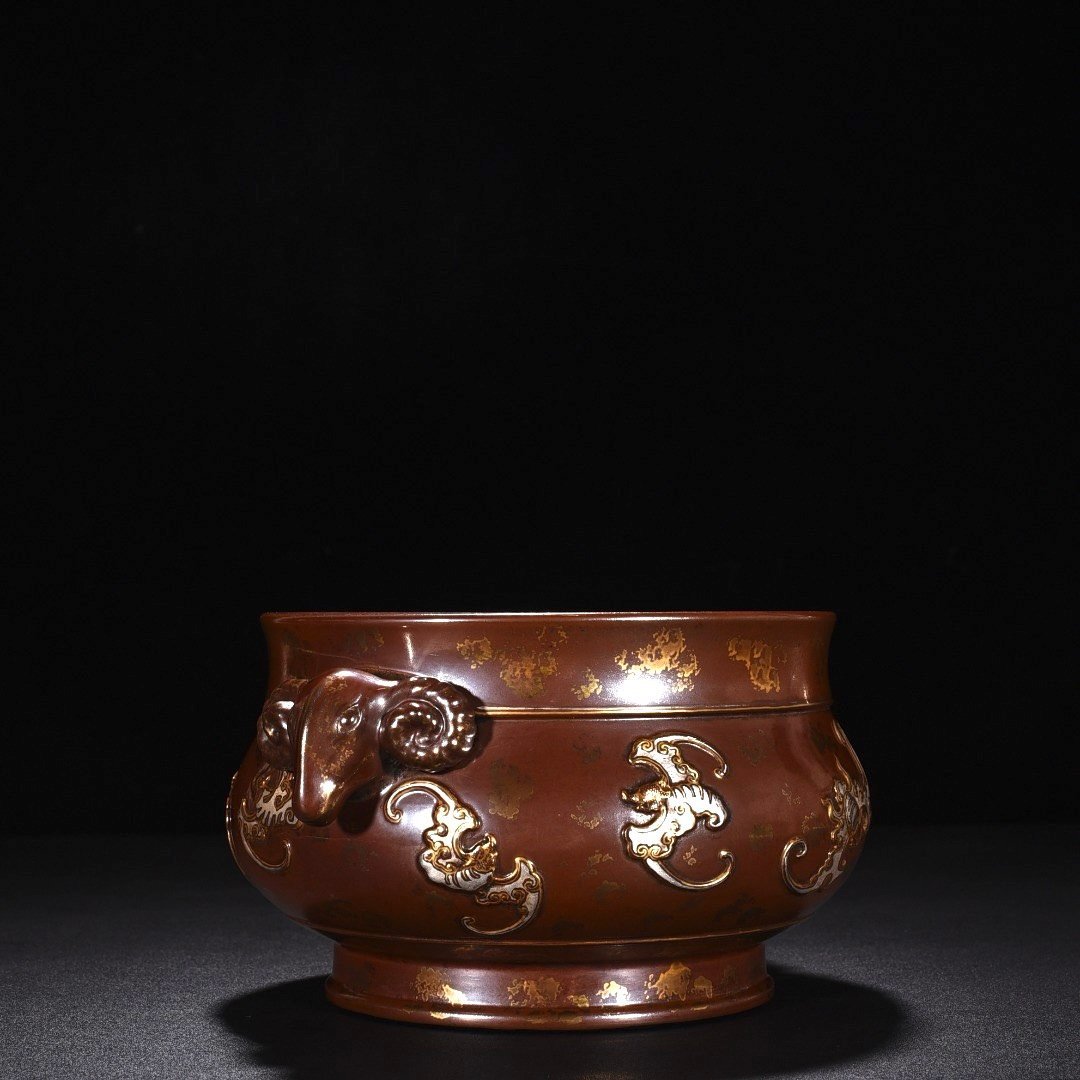 Qing Dynasty Qianlong bronze glaze with gold and silver carvings and nine blessings and sheep’s ears stove
