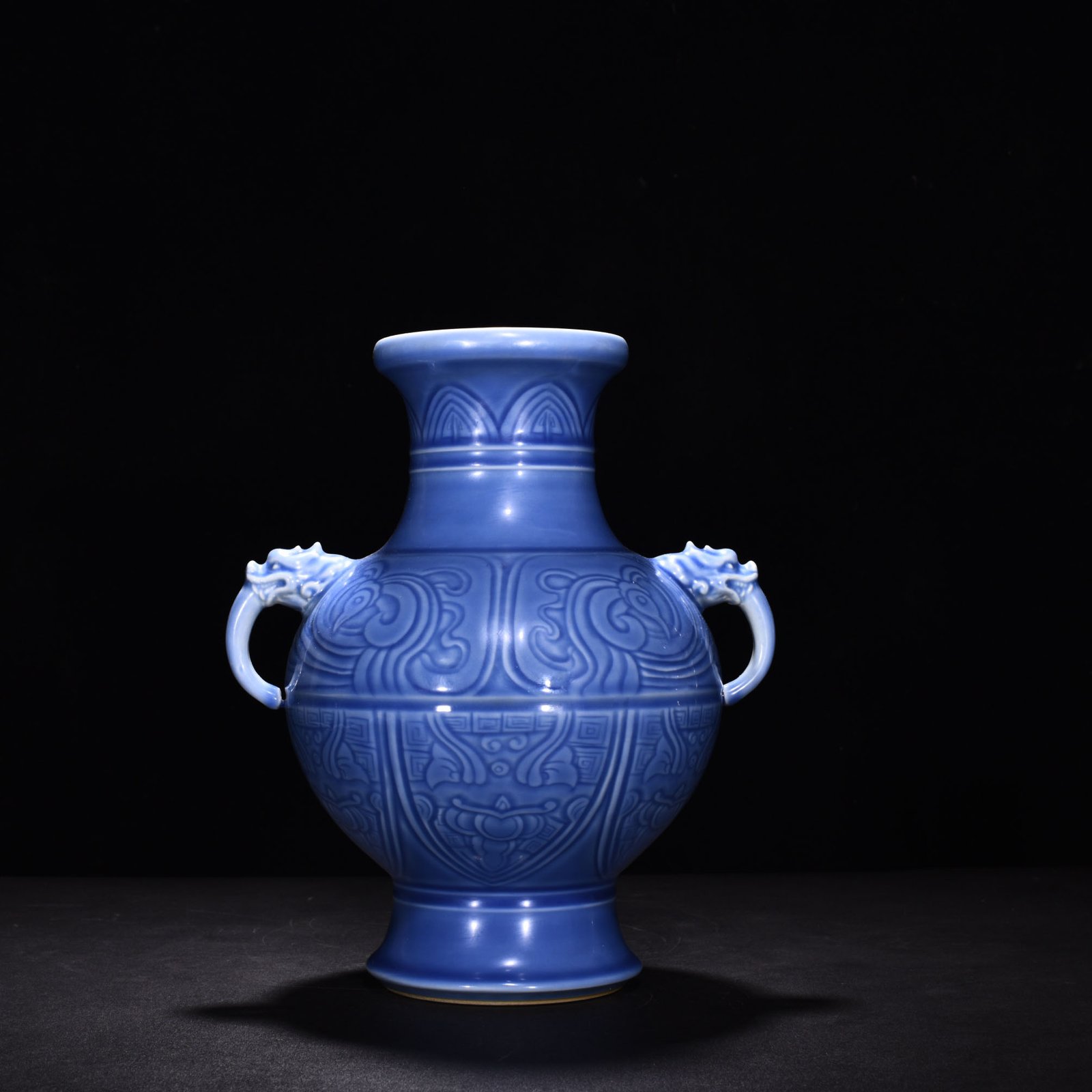 Qing Dynasty Qianlong sky blue glaze phoenix and bird double-eared dish-mouth bottle
