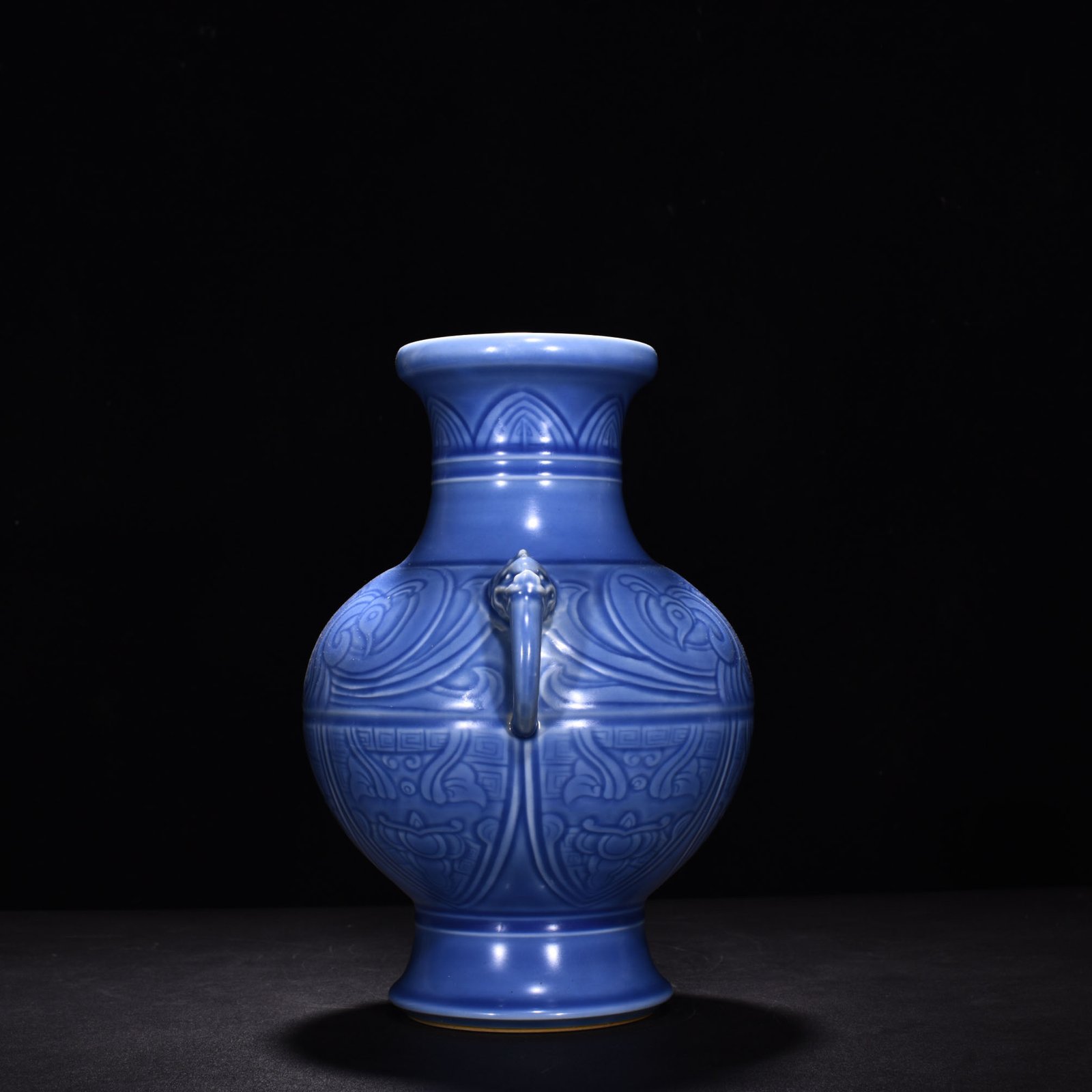 Qing Dynasty Qianlong sky blue glaze phoenix and bird double-eared dish-mouth bottle