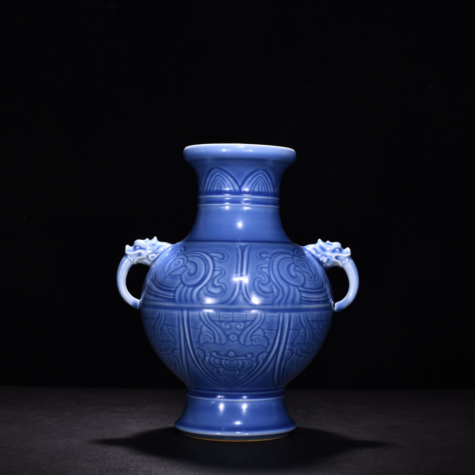 Qing Dynasty Qianlong sky blue glaze phoenix and bird double-eared dish-mouth bottle