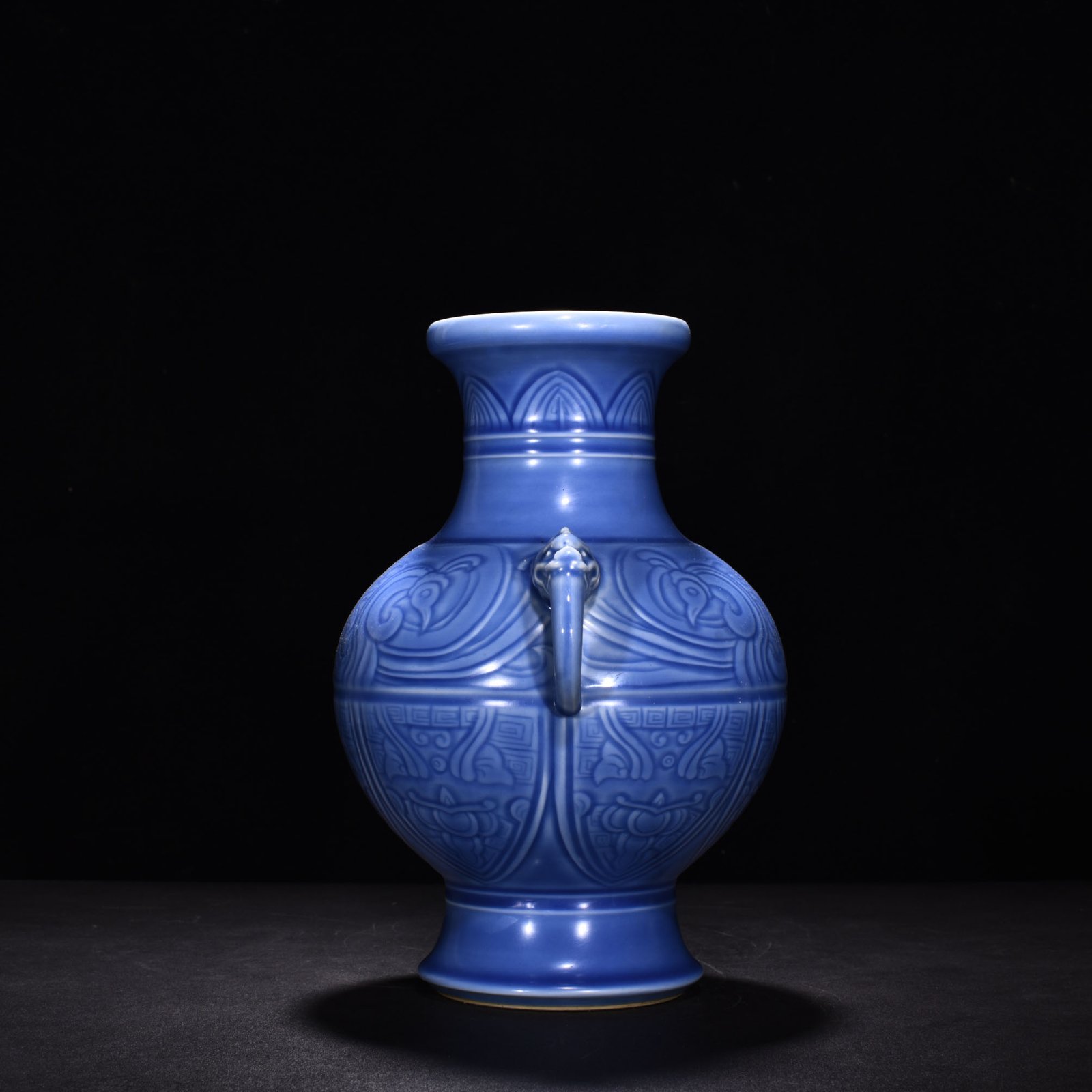 Qing Dynasty Qianlong sky blue glaze phoenix and bird double-eared dish-mouth bottle
