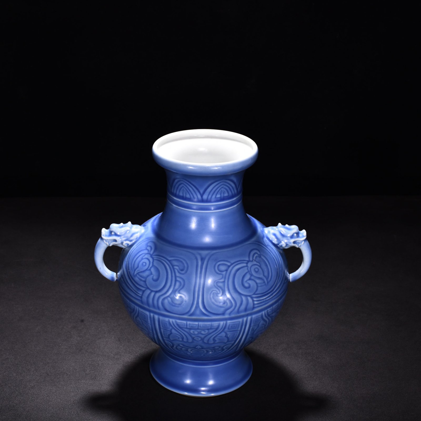 Qing Dynasty Qianlong sky blue glaze phoenix and bird double-eared dish-mouth bottle