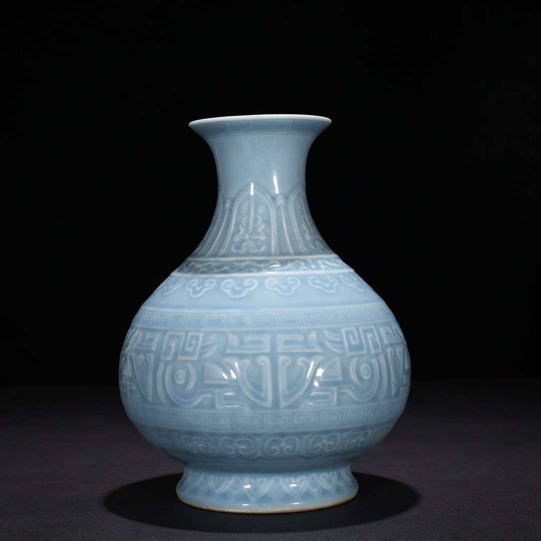 Qing Dynasty Qianlong sky blue glaze carved Taotie jade pot spring vase