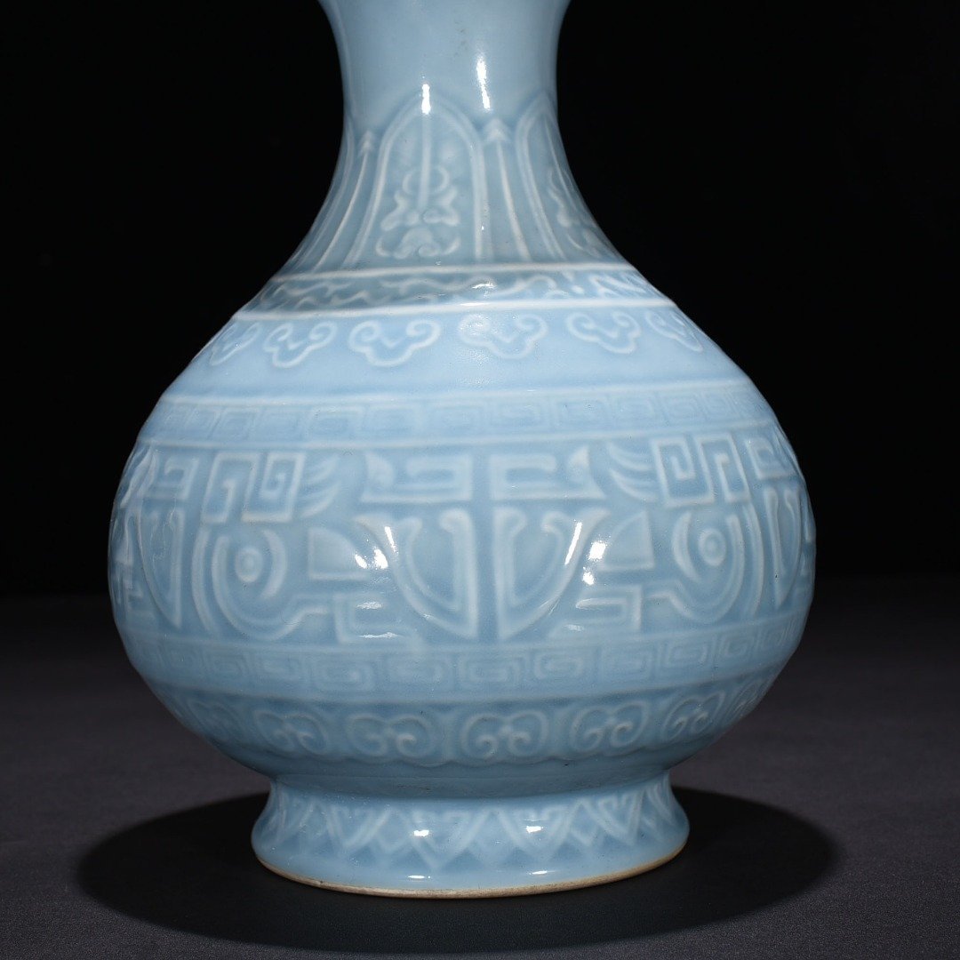 Qing Dynasty Qianlong sky blue glaze carved Taotie jade pot spring vase