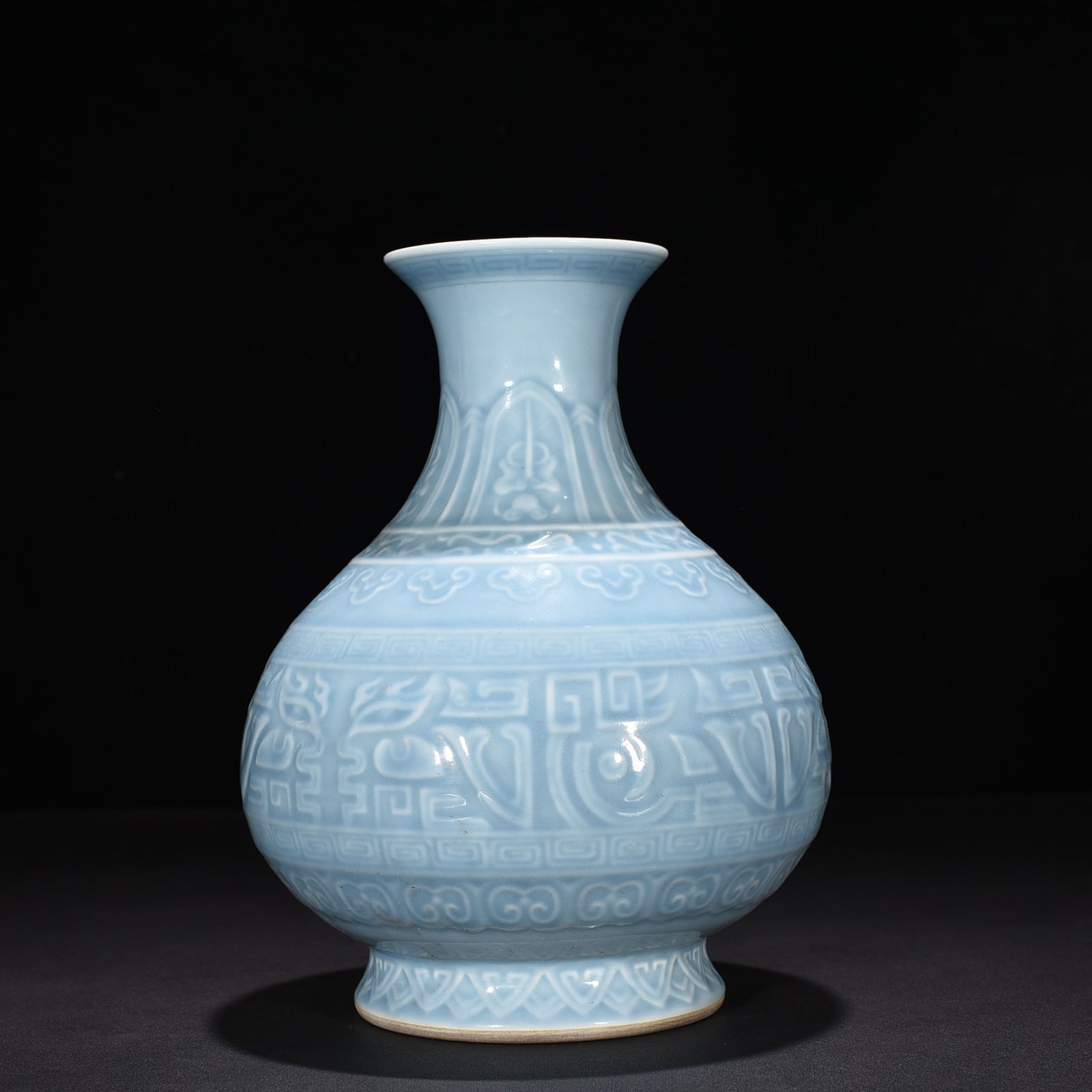 Qing Dynasty Qianlong sky blue glaze carved Taotie jade pot spring vase