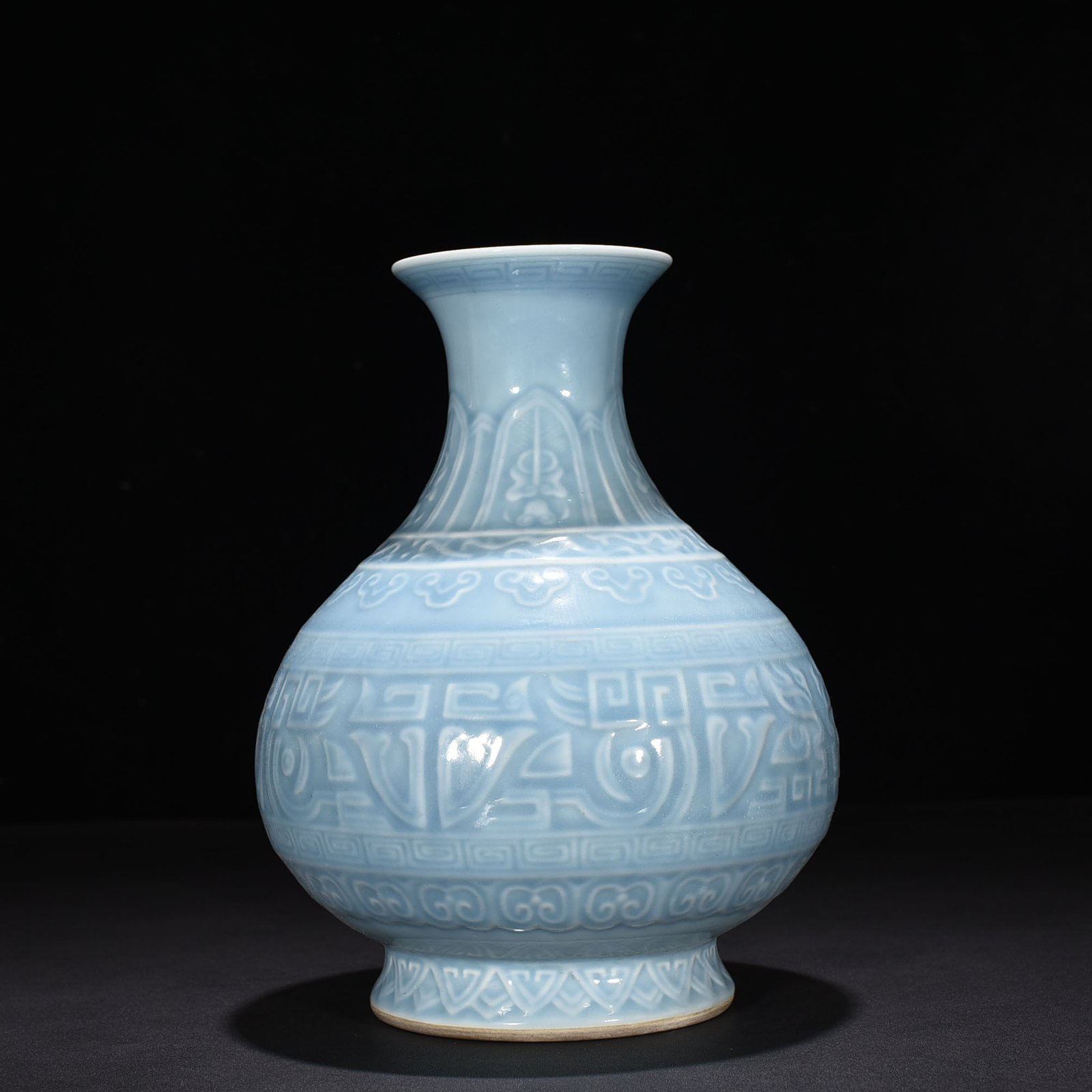 Qing Dynasty Qianlong sky blue glaze carved Taotie jade pot spring vase