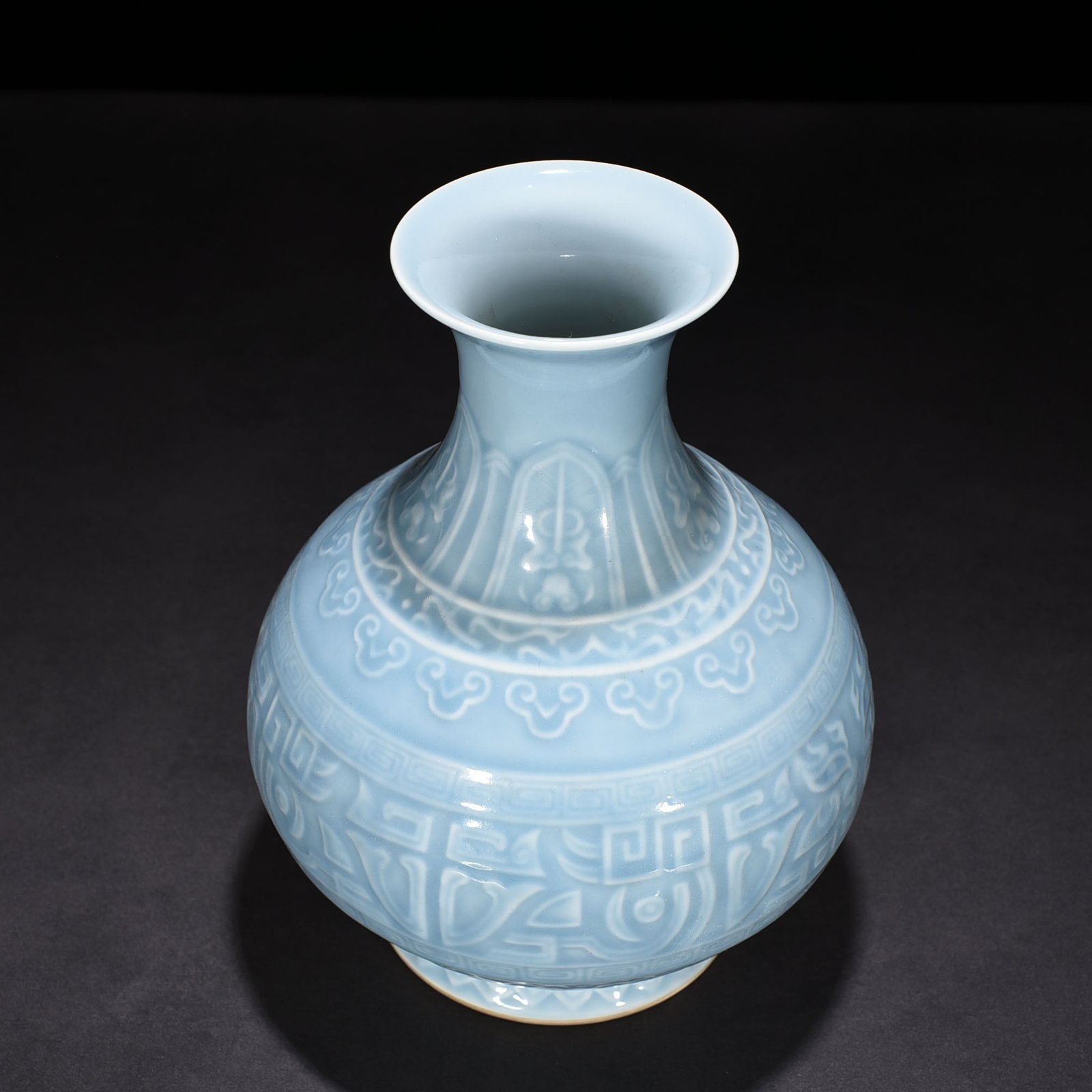 Qing Dynasty Qianlong sky blue glaze carved Taotie jade pot spring vase
