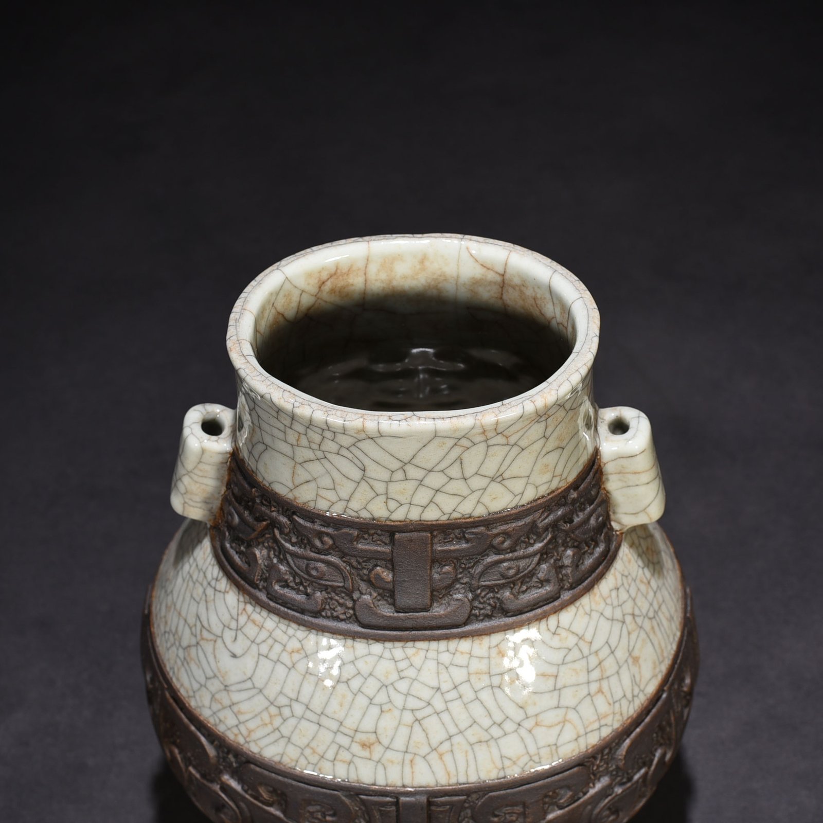 Qing Dynasty Qianlong official kiln carved Taotie through-ear vase