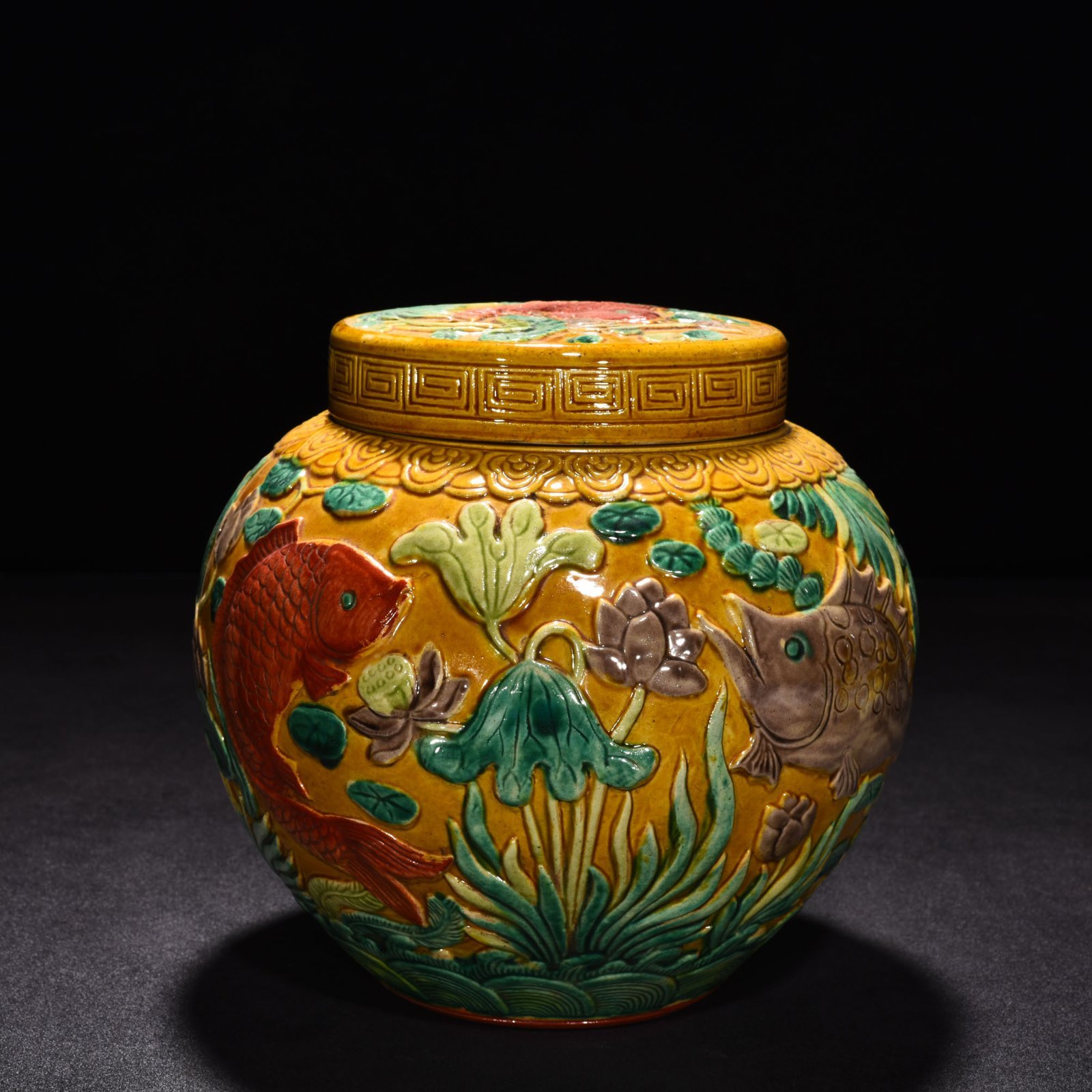 Qing Dynasty Qianlong pastel carved fish and algae lid jar