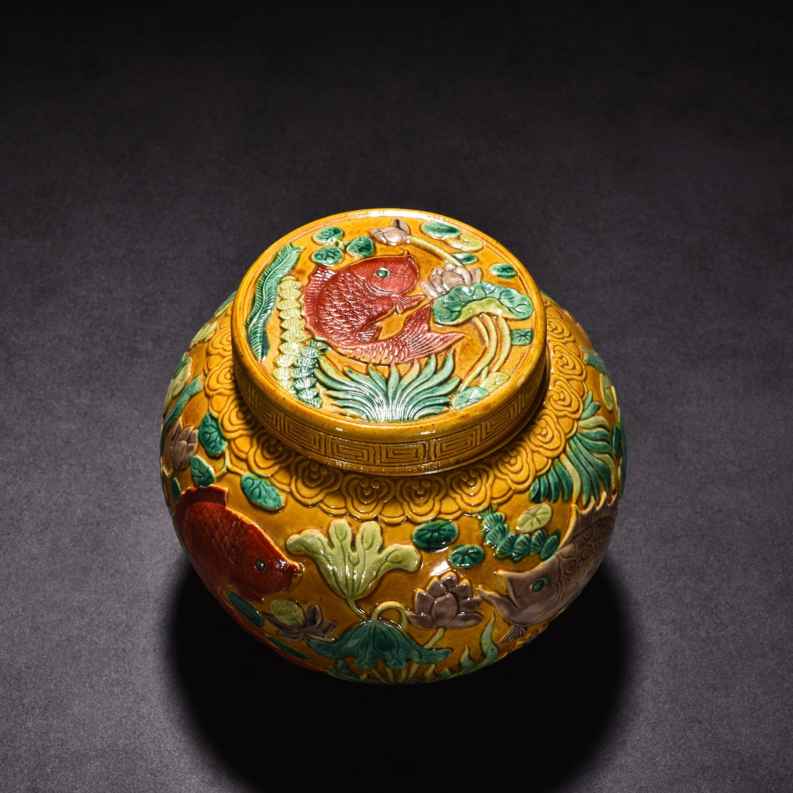 Qing Dynasty Qianlong pastel carved fish and algae lid jar