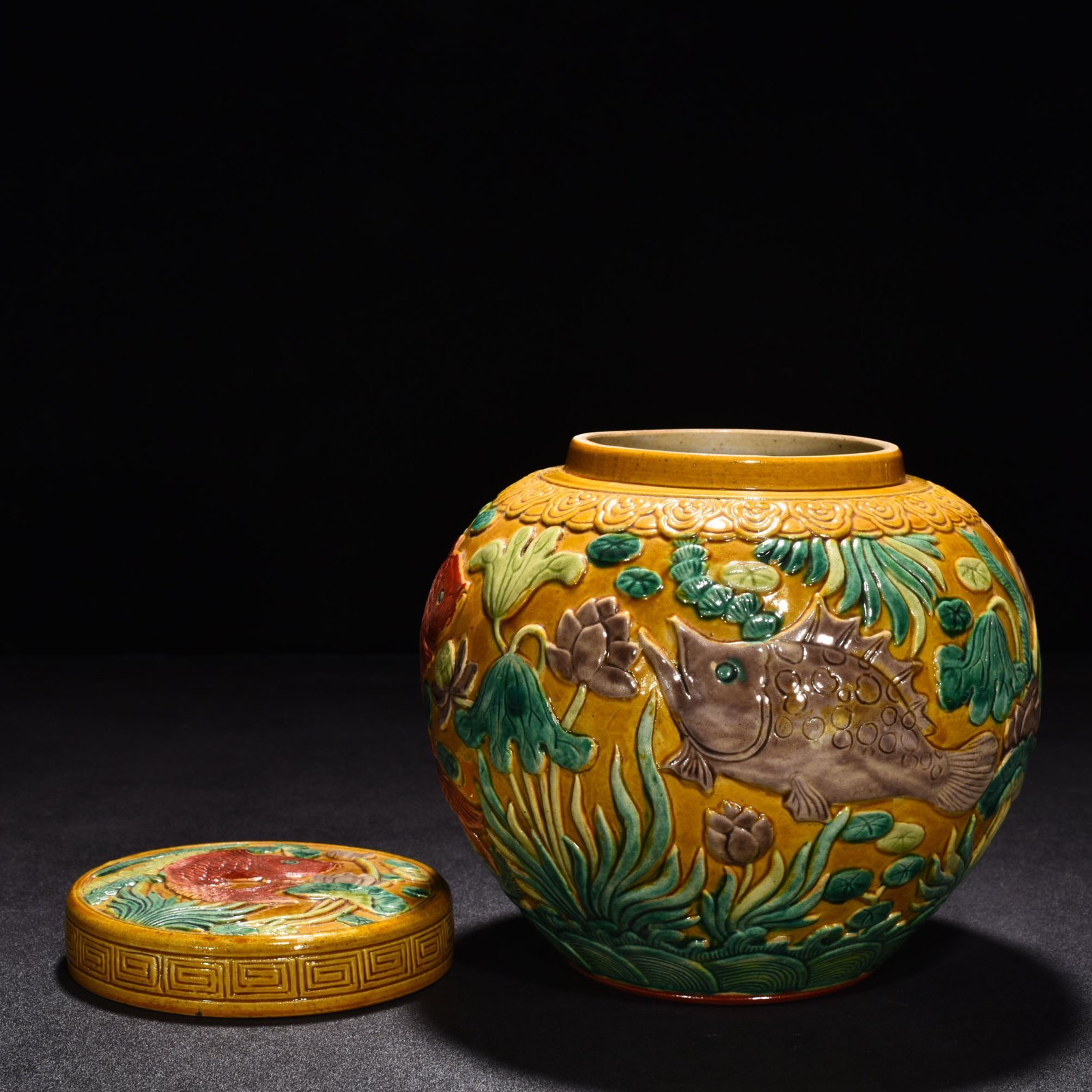 Qing Dynasty Qianlong pastel carved fish and algae lid jar