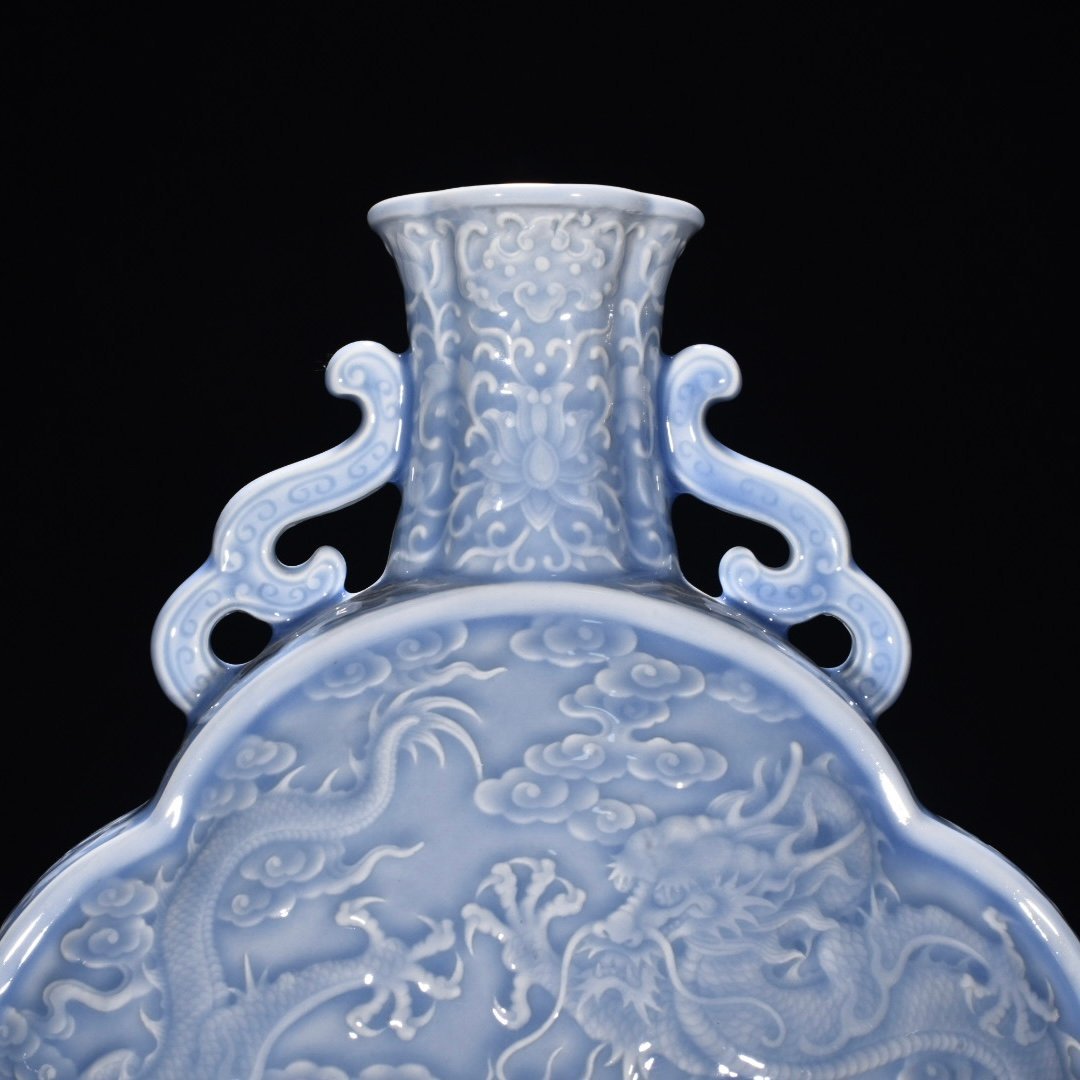 Qing Dynasty Qianlong pink celadon glaze flat bottle with carved double dragons