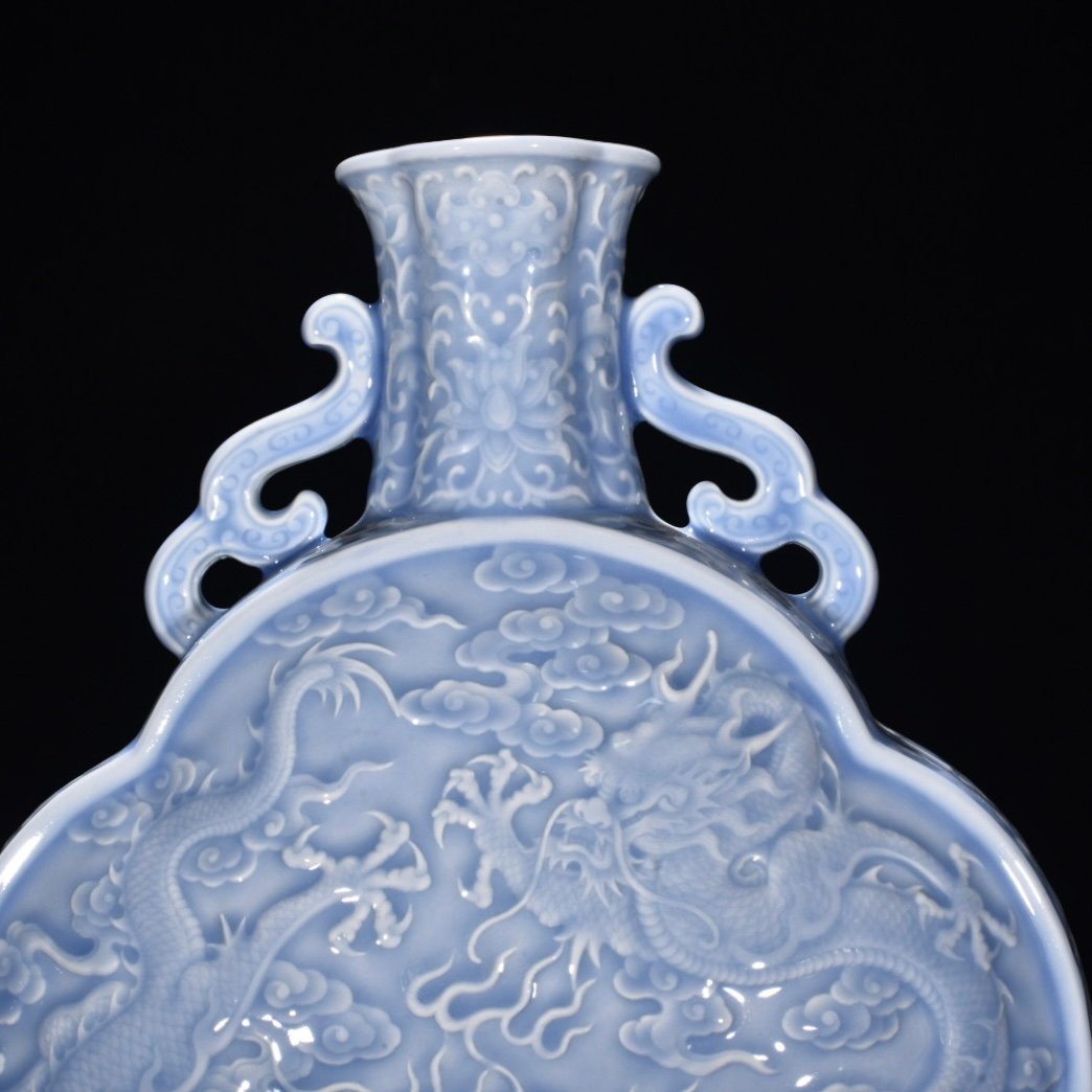 Qing Dynasty Qianlong pink celadon glaze flat bottle with carved double dragons