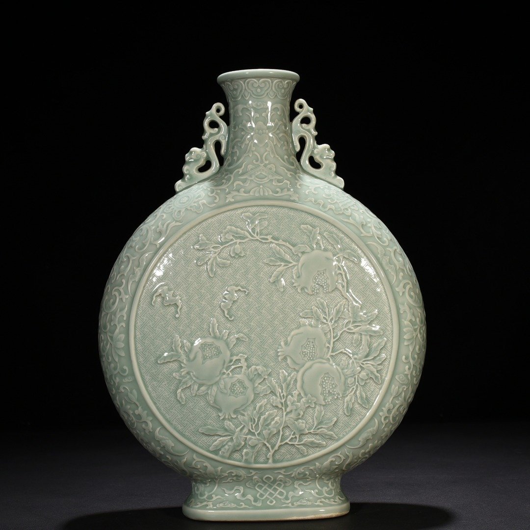Qing Dynasty Qianlong pink celadon glaze carved longevity and multi-child holding moon vase