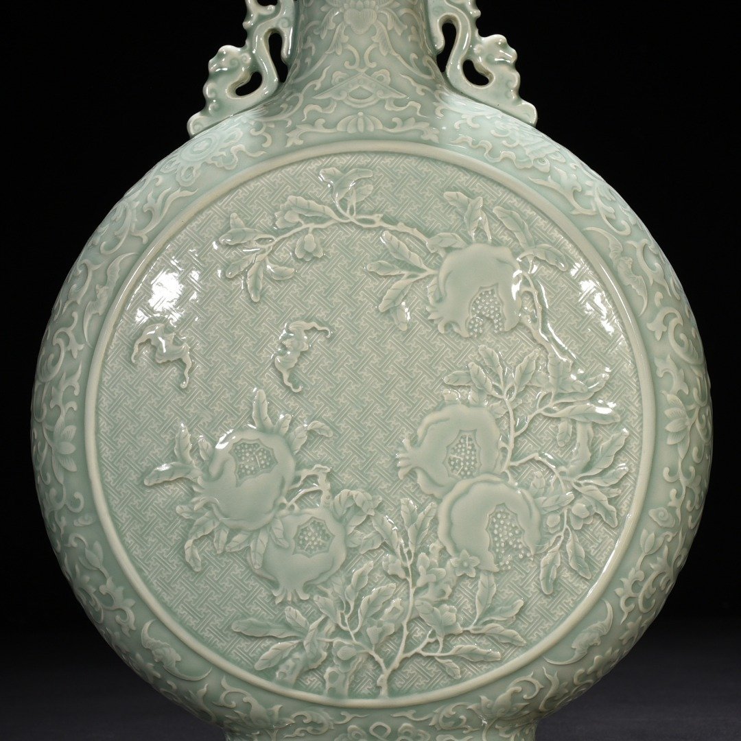 Qing Dynasty Qianlong pink celadon glaze carved longevity and multi-child holding moon vase