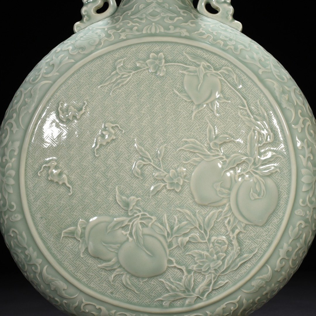Qing Dynasty Qianlong pink celadon glaze carved longevity and multi-child holding moon vase