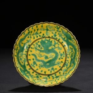 Qing Dynasty Qianlong plain three-color yellow ground engraved five-dragon sunflower mouth plate