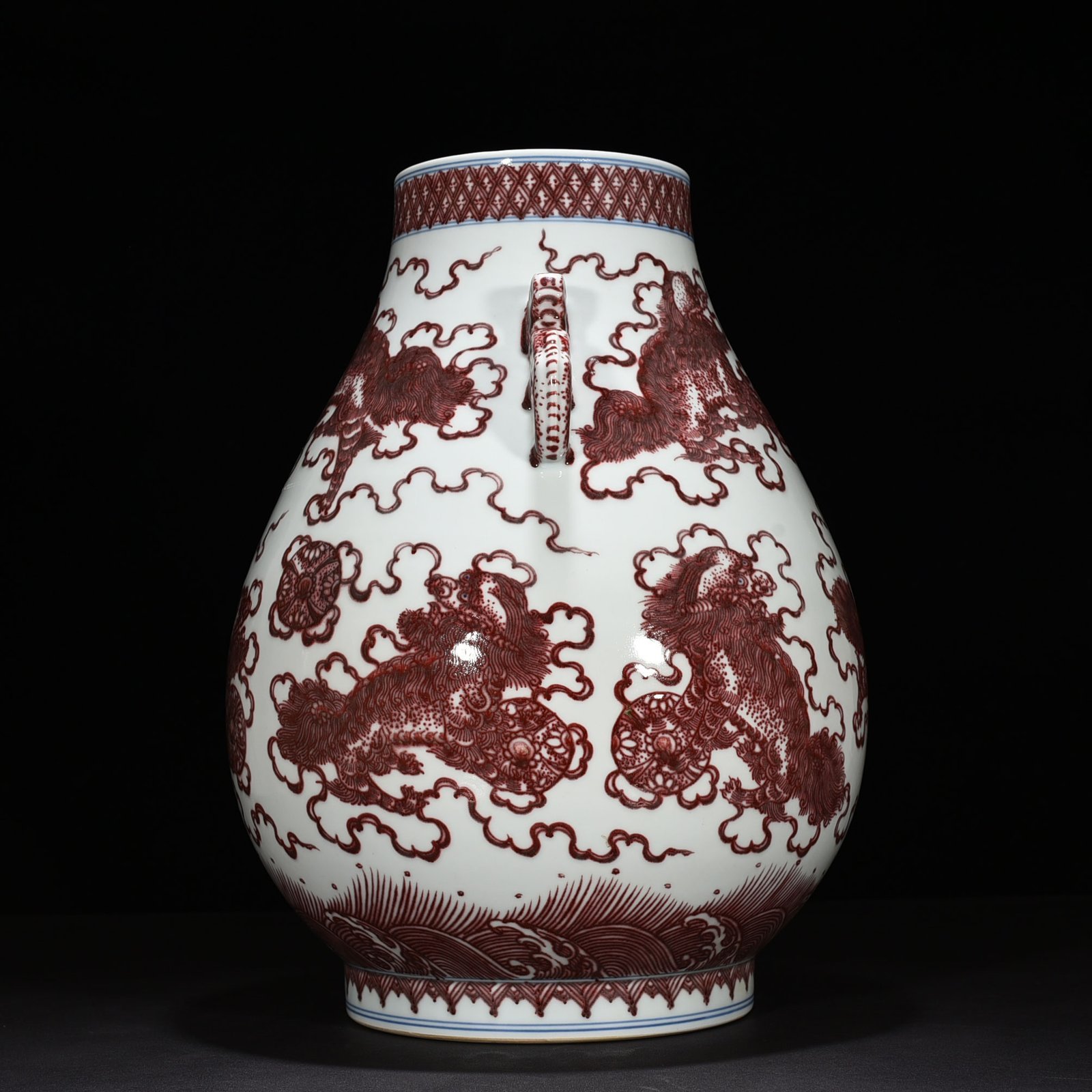 Qing Dynasty Qianlong underglaze red lion rolling hydrangea double-eared statue