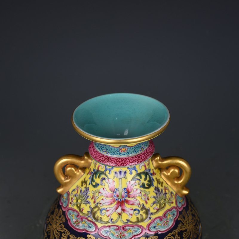 Qing Dynasty Qianlong blue-glazed and gold-embossed hollow bagua binaural vase