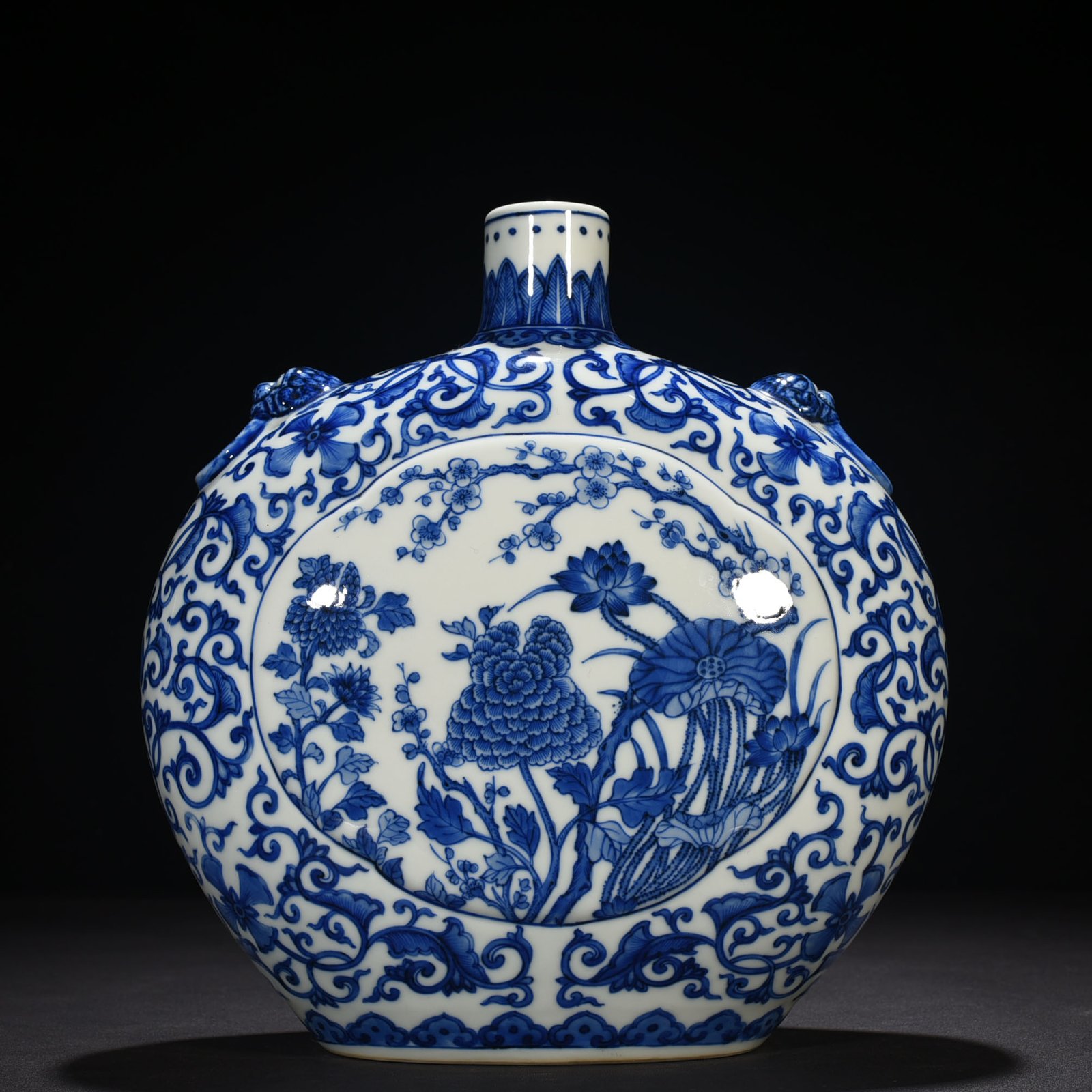 Qing Dynasty Qianlong blue and white windowed four-season flower animal ear flat vase
