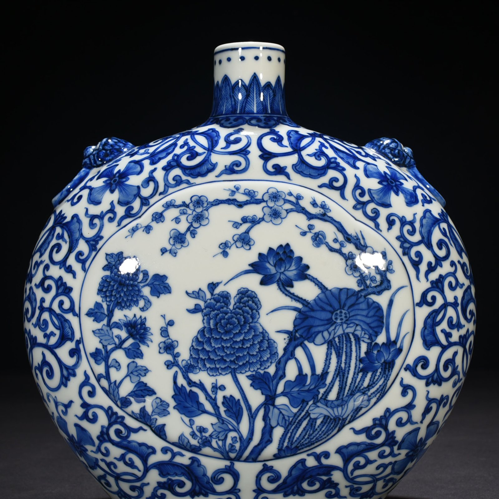 Qing Dynasty Qianlong blue and white windowed four-season flower animal ear flat vase