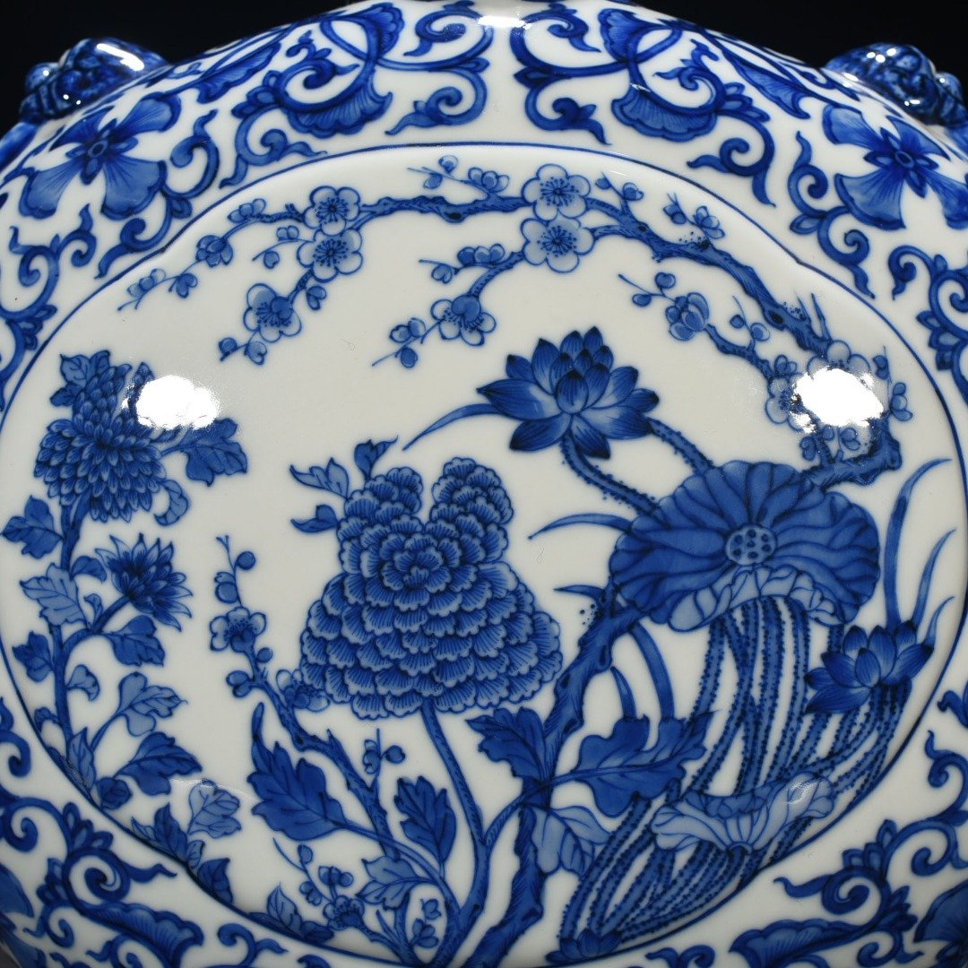 Qing Dynasty Qianlong blue and white windowed four-season flower animal ear flat vase