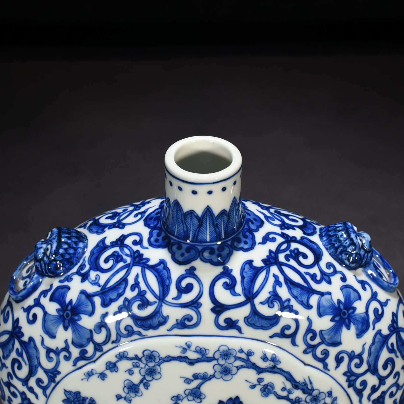 Qing Dynasty Qianlong blue and white windowed four-season flower animal ear flat vase
