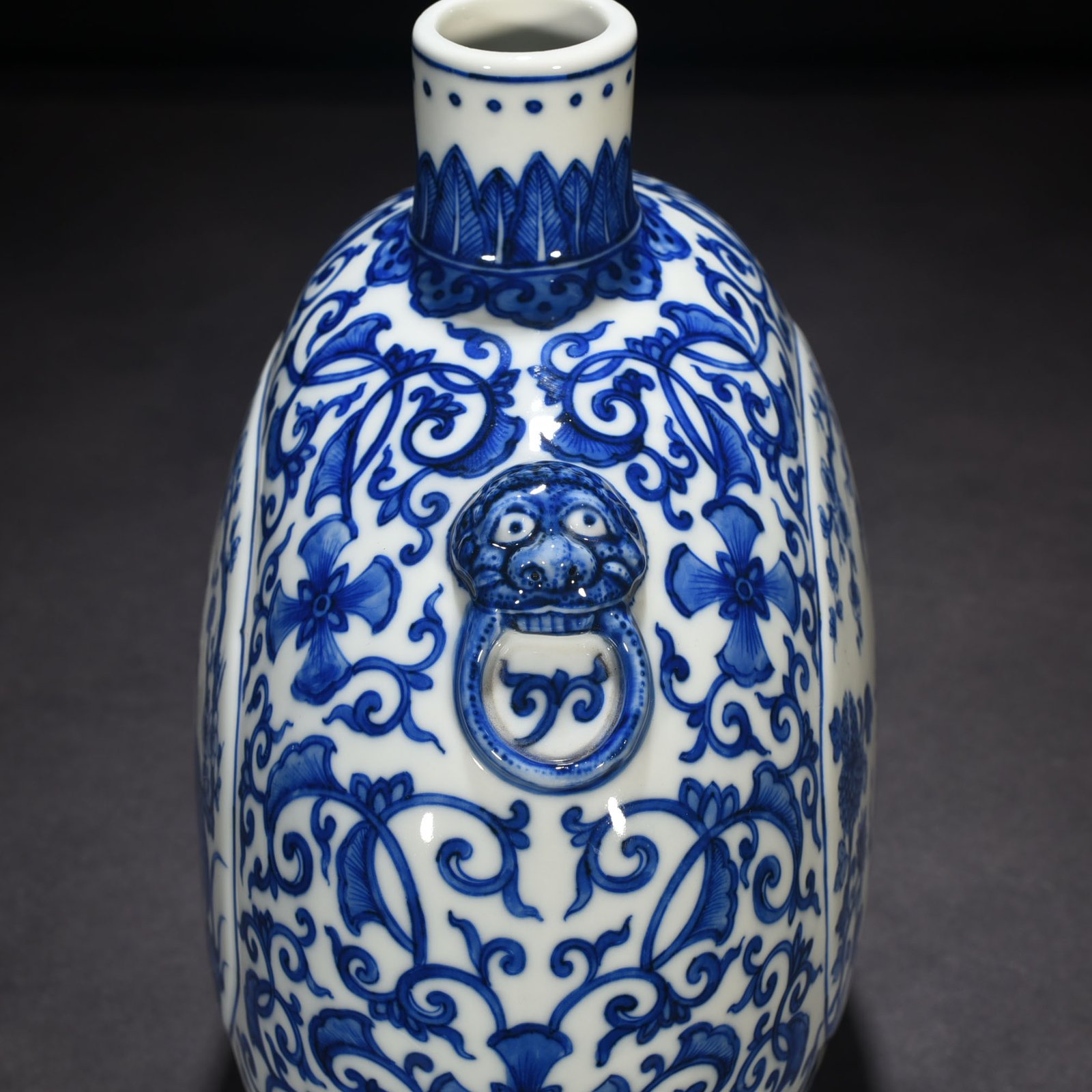 Qing Dynasty Qianlong blue and white windowed four-season flower animal ear flat vase
