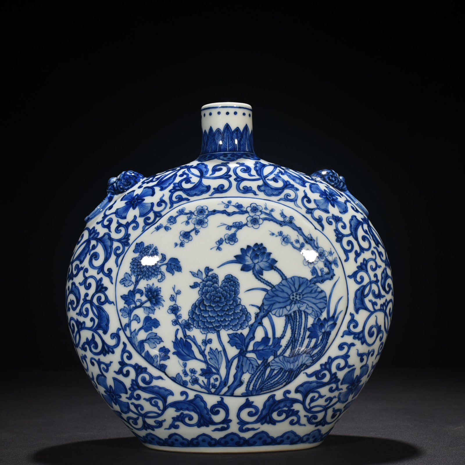 Qing Dynasty Qianlong blue and white windowed four-season flower animal ear flat vase