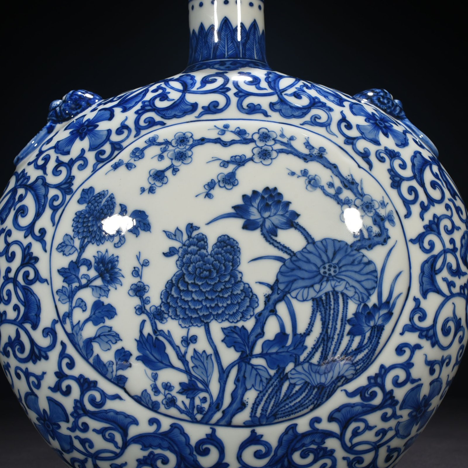 Qing Dynasty Qianlong blue and white windowed four-season flower animal ear flat vase