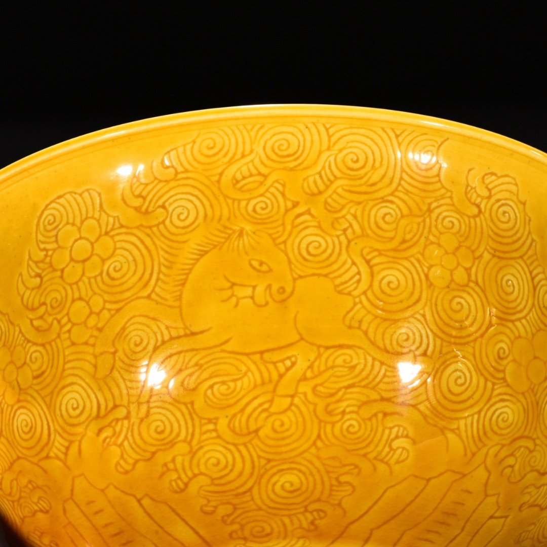 Qing Dynasty Kangxi delicate yellow glaze engraved seahorse bowl