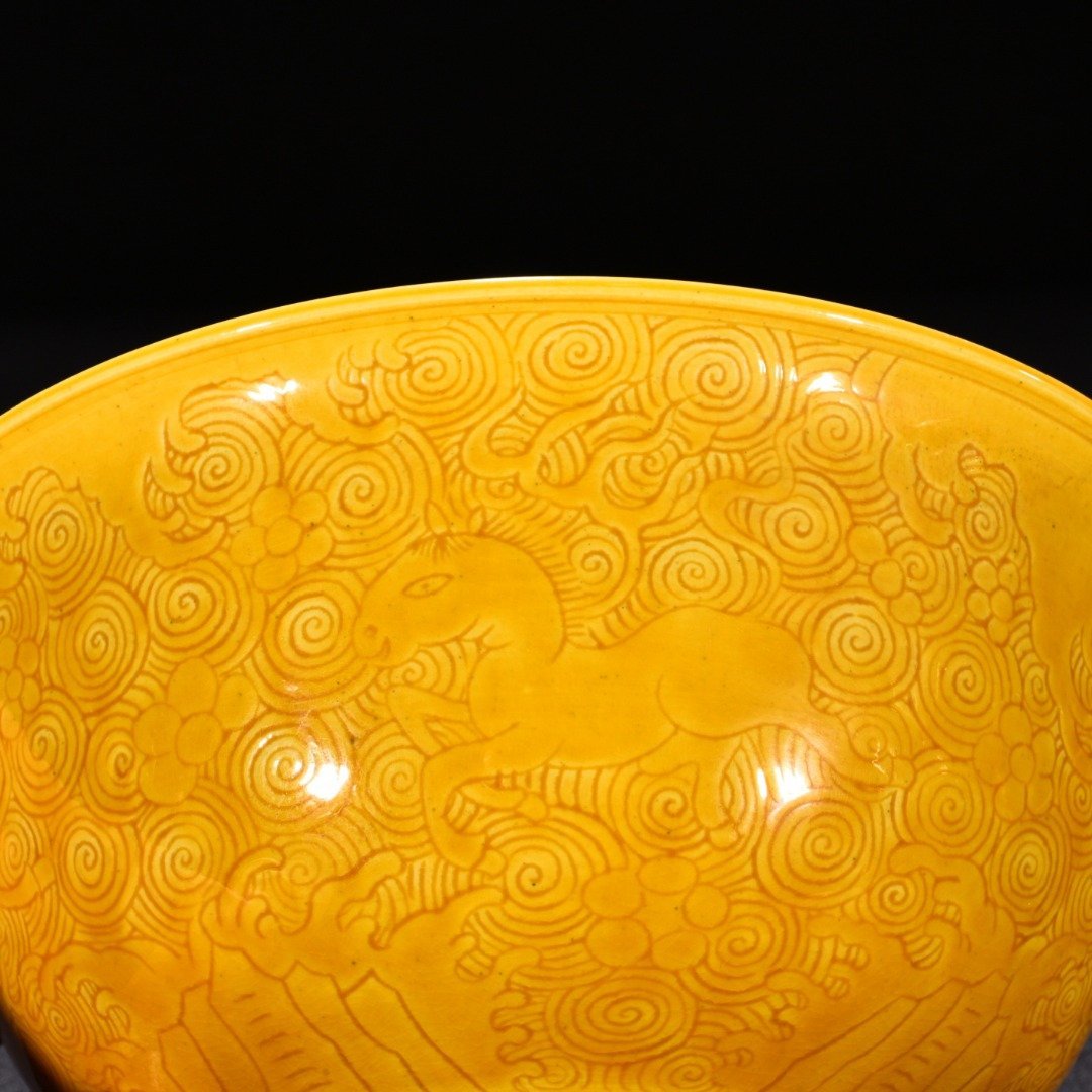 Qing Dynasty Kangxi delicate yellow glaze engraved seahorse bowl